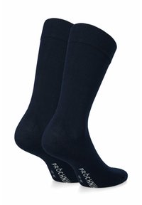 Granatowe skarpetki bawełniane z prążkowanymi ściągaczami i wzmocnionymi piętami. Na boku nadrukowany biały napis „PRÓCHNIK”. Gładka faktura.