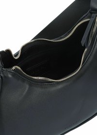 Borsa a mano in pelle nera con chiusura a zip, caratterizzata da una texture liscia, forma curvilinea e dettagli metallici sui cursori. L'interno è foderato e spazioso.