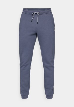 Graue Sweatpants aus weichem Material, mit einem Kordelzugbund, seitlichen Taschen und gerippten Bündchen an den Knöcheln.