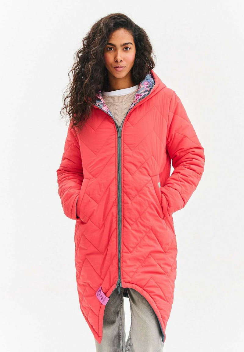 Červený prešívaný dlhý kabát so zipsom, s kvetinovou podšívkou a dvoma bočnými vreckami. Vyrobený z ľahkého materiálu.