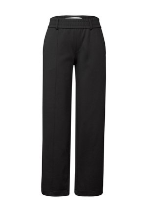 Pantalons larges noirs en tissu doux. Équipés d'une taille élastique, d'un devant plat et de deux coutures latérales descendant sur chaque jambe.