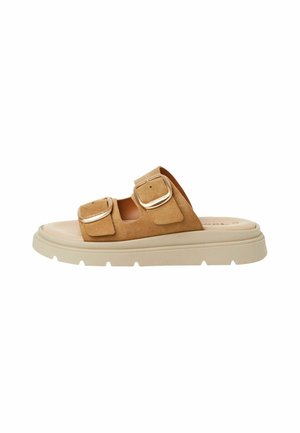 Bruna mockasin-sandaler med två överdimensionerade metallspännen, en tjock beige sula och en slät fotbädd för komfort.