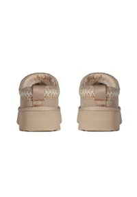 Beige slip-on shoes featuring a soft inner lining, woven detailing at the heel, and a sturdy rubber sole. Simple and functional design.