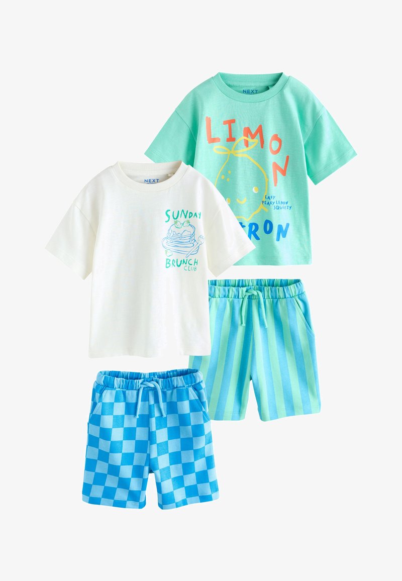 Twee peuteroutfits met korte mouwen en shorts; één wit t-shirt met pannenkoekenprint, blauwe geruite shorts; één turquoise t-shirt met citroenenprint, gestreepte shorts.