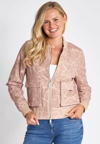 Light pink bomber jacket featuring a subtle abstract pattern, front zipper, two patch pockets, and ribbed cuffs and hem.
