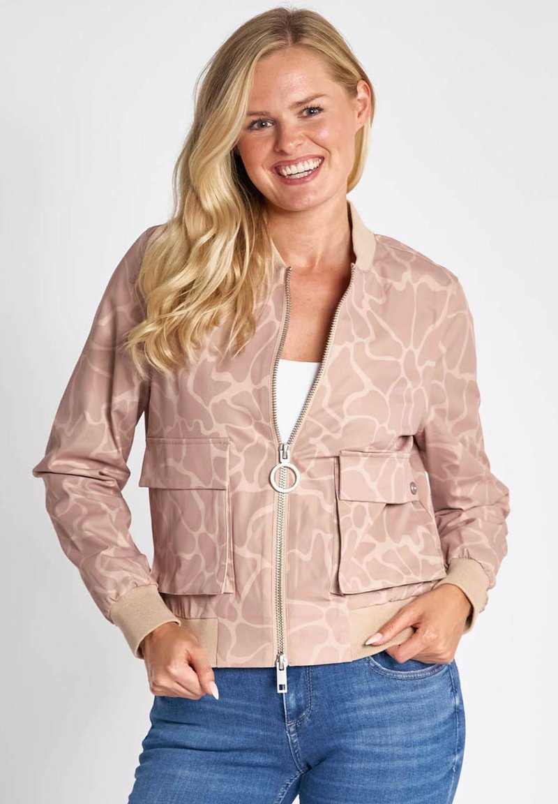 Light pink bomber jacket featuring a subtle abstract pattern, front zipper, two patch pockets, and ribbed cuffs and hem.