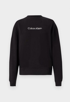 Sweatshirt preto feito de algodão, com gola redonda em canelado, mangas longas e logotipo "Calvin Klein" impresso em branco no peito.