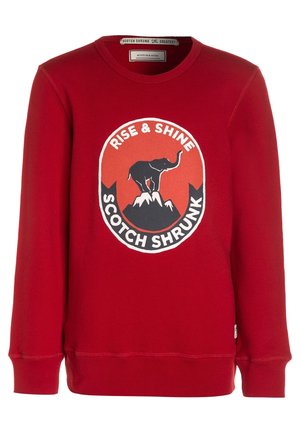 Sweat-shirt rouge à manches longues avec col rond et illustration d'un éléphant debout sur des sommets montagneux, texte « Rise & Shine Scotch Shrunk. »