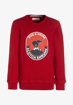 Sweat-shirt rouge à manches longues avec col rond et illustration d'un éléphant debout sur des sommets montagneux, texte « Rise & Shine Scotch Shrunk. »