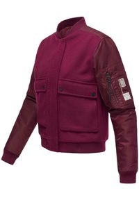 Burgundy bomber jacket with wool body and synthetic sleeves, featuring two chest pockets and a zippered arm pocket with branding details.