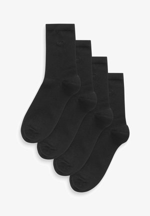 Svarta bomullssockor, fyrpack, ribbat mönster, medelhög tjocklek, sömlig tå, med en liten "next"-logotyp nära den övre kanten.