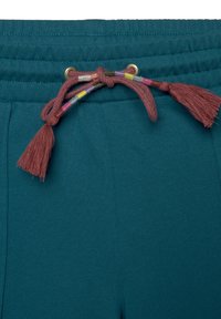 Teal joggers med ribbad midja, med en flerfärgad dragsko med tofsar och metallic öglor för justerbar passform.