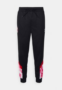 Svarta sportbyxor med dragsko i midjan, smal passform och röda och vita tie-dye detaljer på de nedre sidorna.