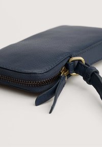 Portafoglio in pelle blu navy con superficie testurizzata, chiusura con zip, hardware color oro e tracolla staccabile.