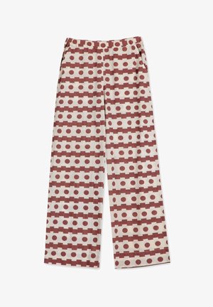 Pantalons ample en tissu léger, avec un fond beige orné de motifs circulaires et rectangulaires rouges. Comprend des poches.