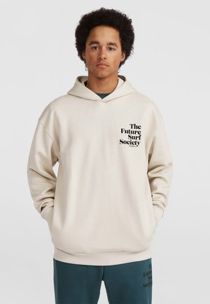 Light beige hoodie with a front pocket, drawstring hood, and printed text "The Future Surf Society" in black. Soft, relaxed fit design.
