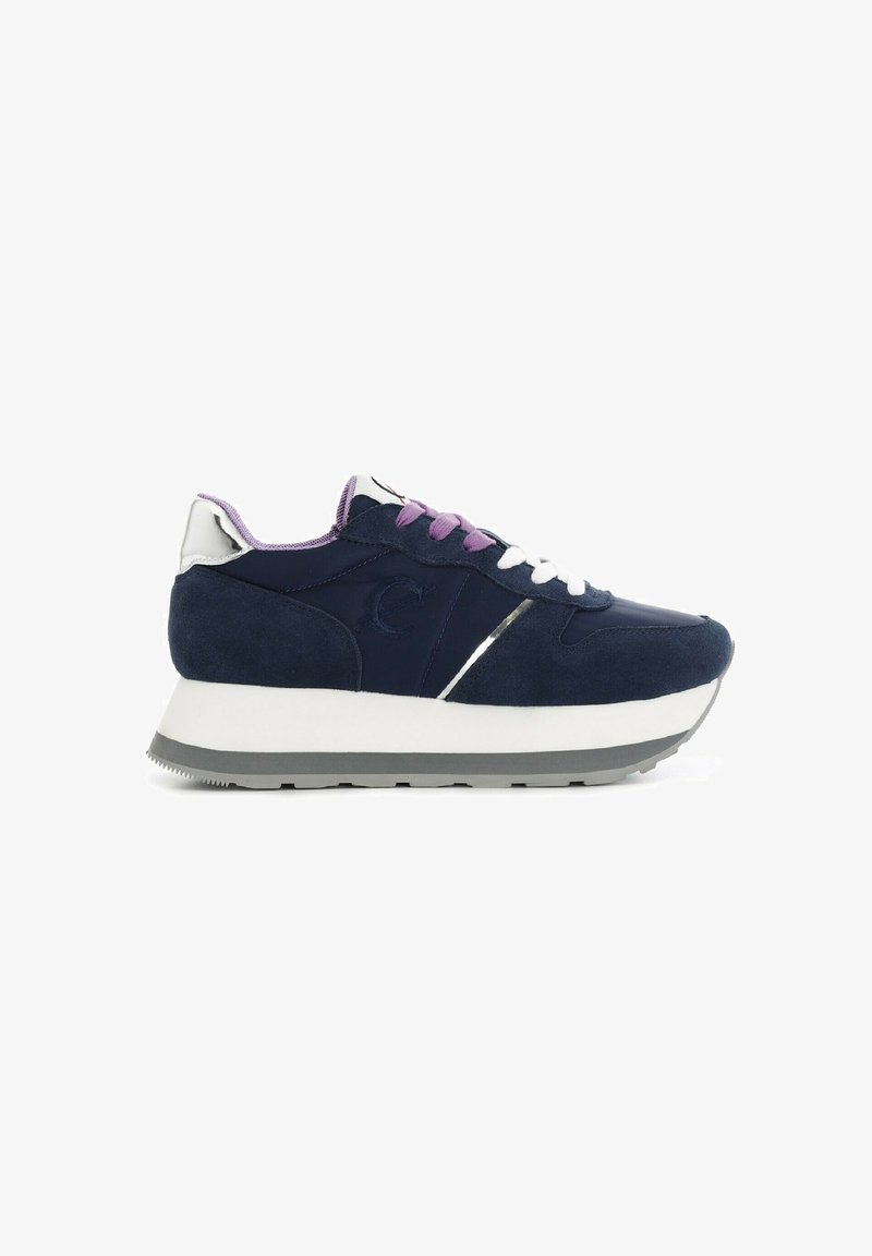 Navy blue suede sneaker with white and gray sole, purple accents, and silver detailing. Features a rounded toe and cushioned insole.