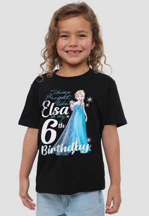 Black t-shirt featuring Elsa from Frozen in a blue gown, with text reading "Shine Bright like Elsa on my 6th Birthday" in white and blue.