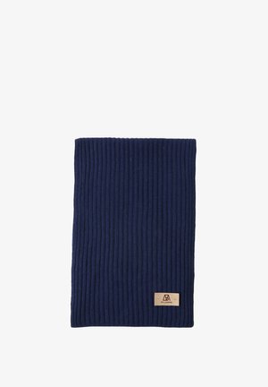 Blue knitted beanie and scarf, paired with a cream fuzzy sweater. Includes blue gloves and a tan pair of pants. Tan label on the scarf.