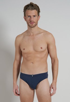 Culottes imprimées bleu marine avec motif à carreaux, taille élastique et logo subtil au centre, fabriquées en tissu lisse.