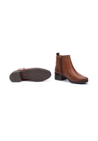Braune Leder-Stiefeletten mit seitlichem Reißverschluss, spitzer Zehenform und einem 5 cm hohen Blockabsatz. Strukturiertes Gummisohle mit Sternmuster-Akzenten.