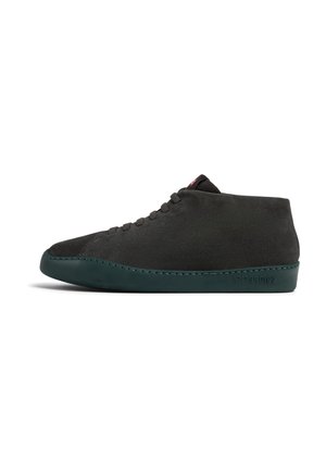Black suede high-top shoe with a rounded toe, green rubber sole, and dark eyelets. Features a minimalistic design with subtle stitching detail.