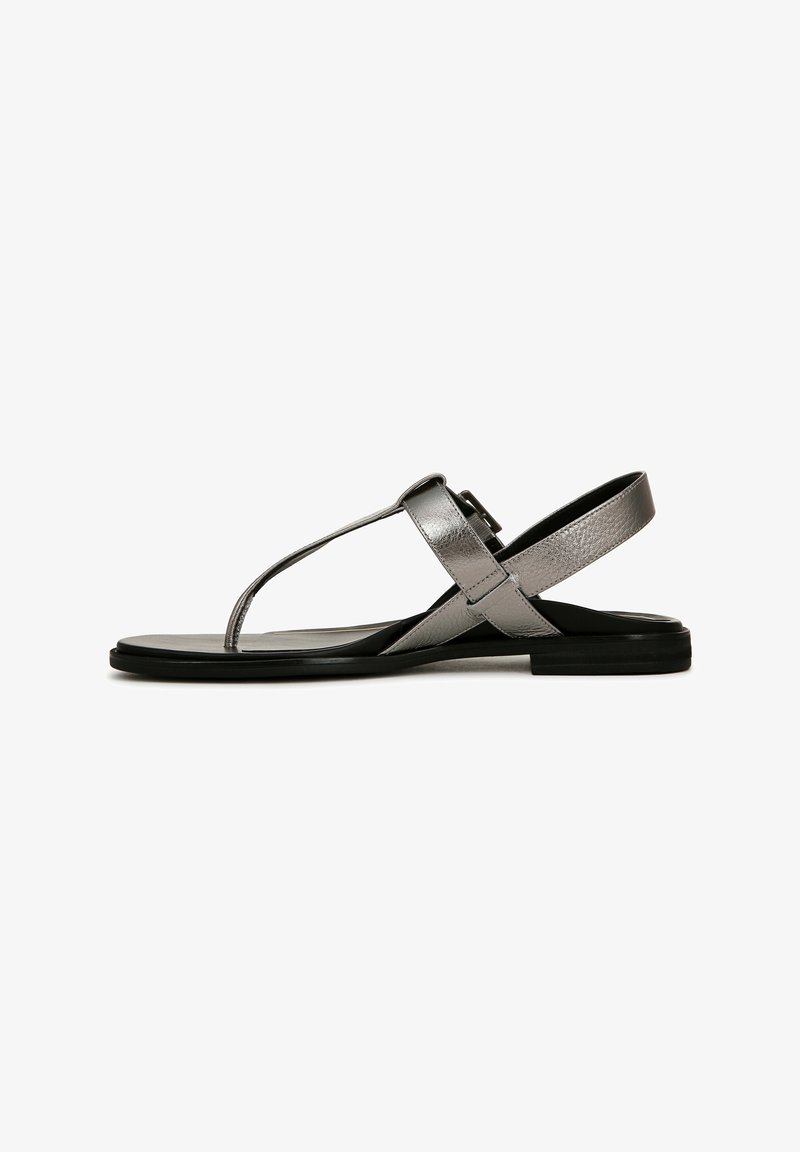 Silver metallic sandals with a T-strap design, cross buckles, and a flat black sole. Smooth texture with a simple, sleek silhouette.