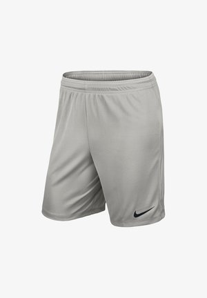 Short de sport gris clair avec une ceinture élastique et un petit logo Nike Swoosh noir sur la partie inférieure de la jambe gauche.