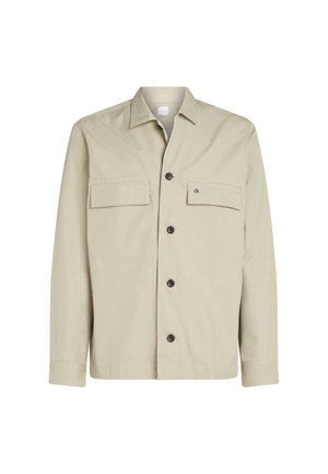 Giacca beige con bottoni, realizzata in misto cotone, con due tasche sul petto, colletto e bottoni neri. Dettaglio sottile del logo sulla tasca.