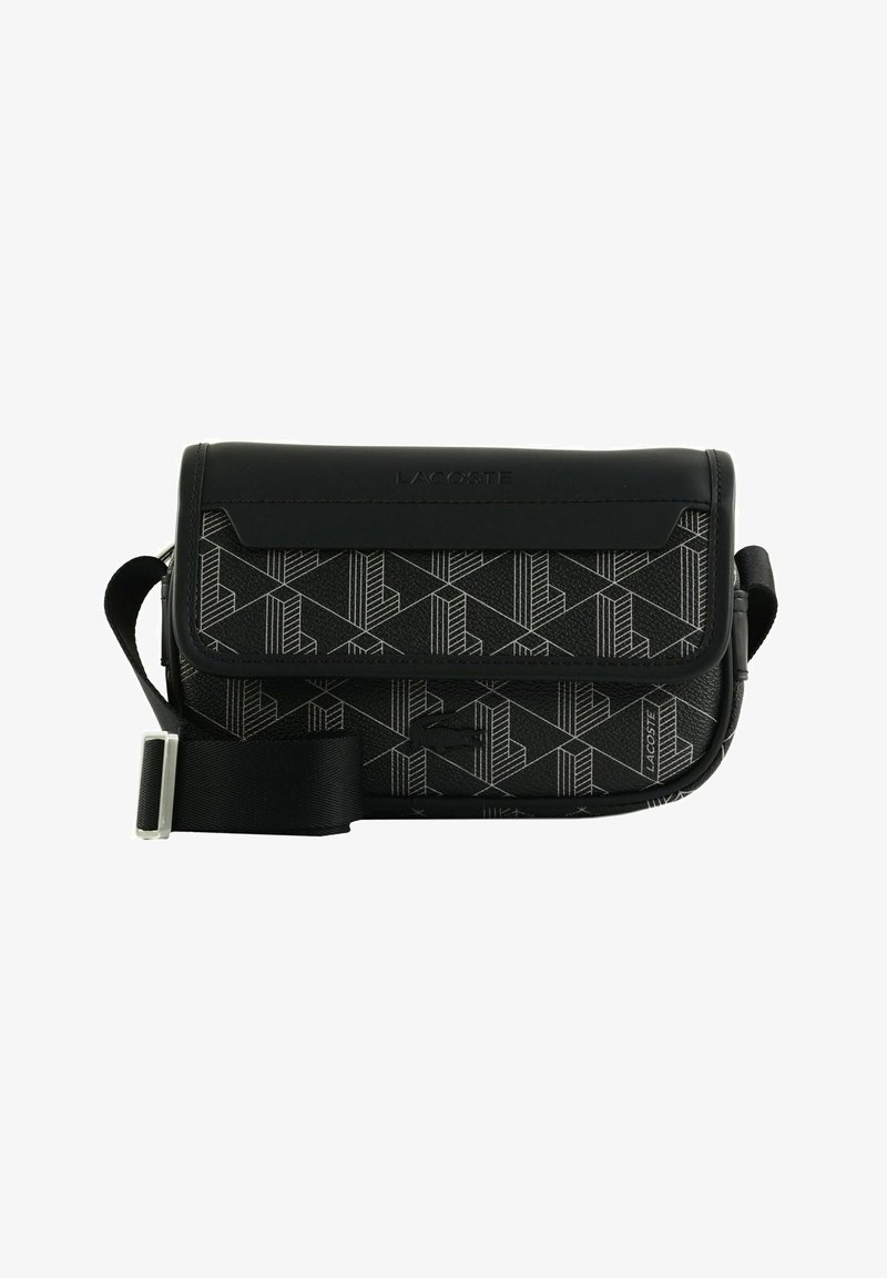 Black Lacoste crossbody bag with geometric pattern, front flap, and adjustable strap. Lacoste logo visible on front and top.