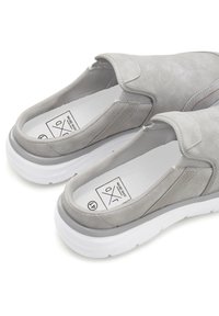 Slip-on shoes in light gray suede with elastic side panels, white rubber sole, and contrasting stitching detail. Inner lining visible.