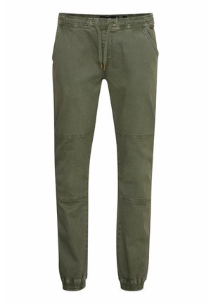 Olive green tapered jogger pants made of cotton, featuring an elastic waistband with drawstring, side pockets, and elastic cuffs at ankles.