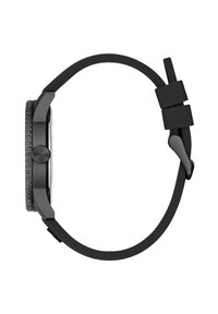 Black analog watch with a textured bezel, a square case, and a smooth black silicone strap. The crown sits at 3 o'clock.