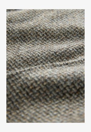 Woven fabric in shades of brown and gray. Features a textured, checkered pattern with a soft, slightly fuzzy surface.
