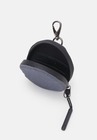 Round black and blue zippered pouch made of fabric and synthetic material, featuring a clip and textured zipper pull for easy access.
