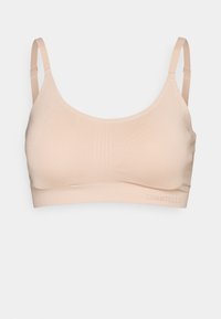 Light tan bralette made of smooth fabric. Features thin adjustable straps, a scoop neckline, and subtle lined texture details. Logo at the band.
