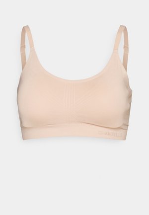 Bralette em tom bege claro feito de tecido suave. Apresenta alças finas ajustáveis, decote arredondado e detalhes de textura riscada sutis. Logótipo na faixa.