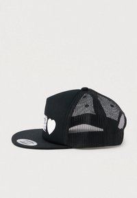 Black mesh trucker cap with flat brim and white heart and beverage can graphic on front panel.