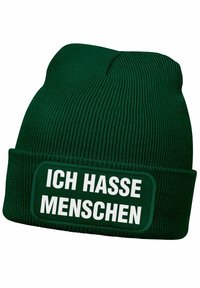 Green knit beanie with a cuff, featuring a rectangular patch with the white text "ICH HASSE MENSCHEN." Fabric has a ribbed texture.