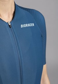 Blue cycling suit with short sleeves, featuring a front zipper and textured side panels. "BIORACER" logo on the chest in white. Smooth fabric finish.