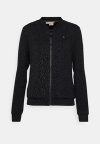 Svart bomberjacka med dragkedja, utrustad med ett prickigt mönster, ribbade ärmslut och en mjuk tygkvalitet.