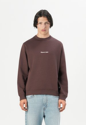 Brown crewneck sweatshirt made of cotton with ribbed cuffs and hem. Features white embroidered text on the chest. Relaxed fit.