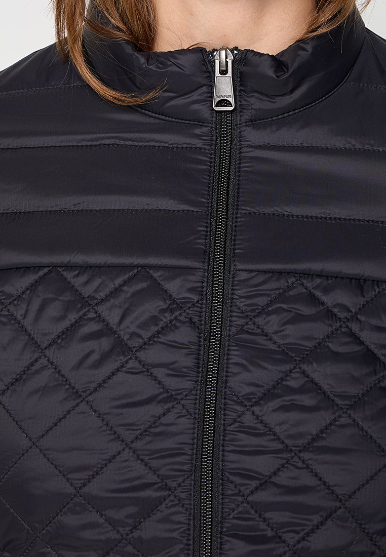 Schwarze gesteppte Jacke mit horizontalem und rhombischen Steppmuster, ausgestattet mit einem mittigen silbernen Reißverschluss und Stehkragen.