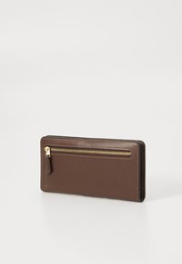 Brown leather wallet with gold zipper pocket on front, rectangular shape, and visible tan stitching on edges, set against a white background.