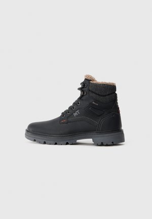 Black waterproof boot with a textured leather upper, gray rubber sole, and a soft, tan fleece collar. Features metal eyelets and orange accents.