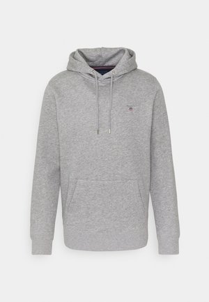Graue Hoodie aus weichem Stoff mit einer Vordertasche, gerippten Bündchen, Kapuze mit Kordelzug und einem kleinen Logo auf der Brust.