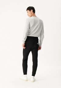 JOTT SANTIAGO - Pantalones deportivos - noir