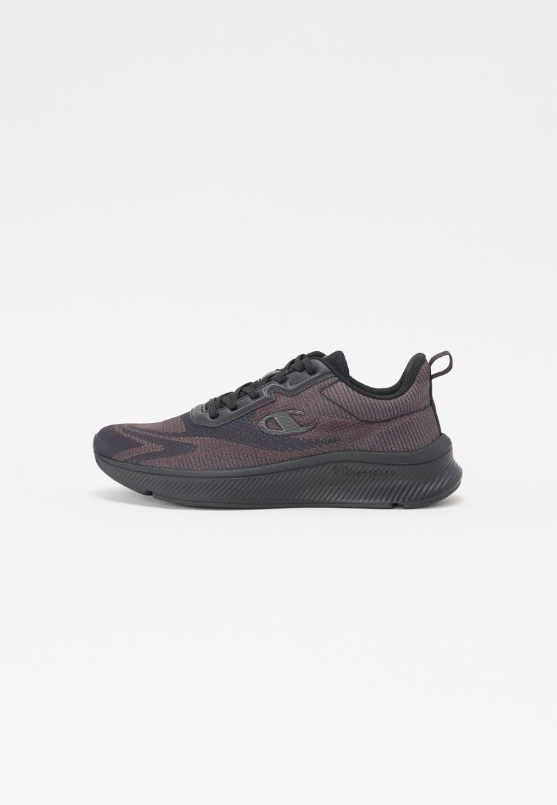 Black athletic shoe with a textured mesh upper, contrasting dark accents, and a thick rubber sole. Features laces and a rear pull tab.