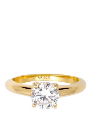 Bague en or avec une seule pierre précieuse claire, ronde et taillée en brillant, maintenue par quatre griffes, marquée "925" à l'intérieur de l'anneau.