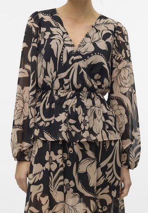 Woman wearing a black sheer blouse and skirt set with beige floral print, V-neck, gathered waist, and long puffed sleeves.